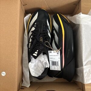Adidas Men's Black and White Athletic Shoes with Yellow Accents